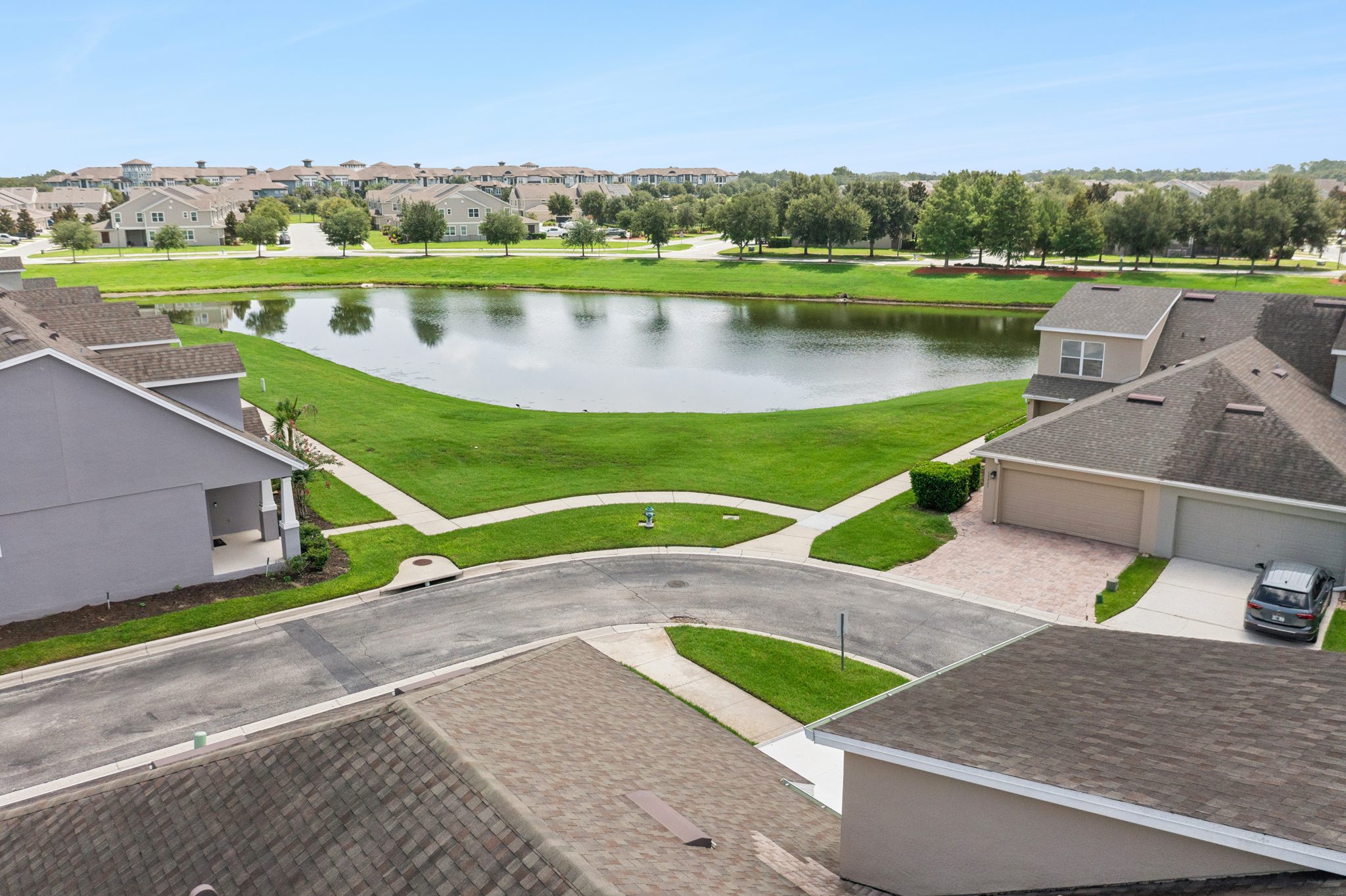 Aerial of the neighborhood pond and surrounding homes at 13449 Carroway St, Windermere