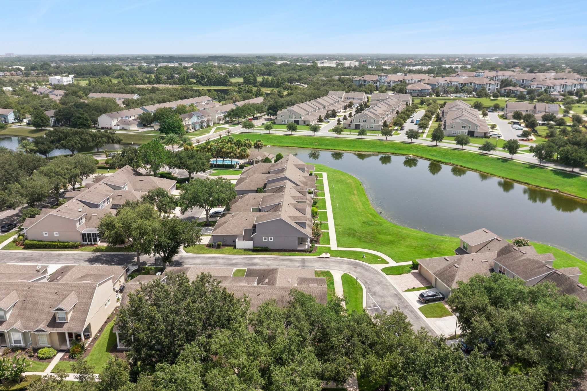 Wide aerial of Merrick Landing with water and conservation views at 13449 Carroway St, Windermere